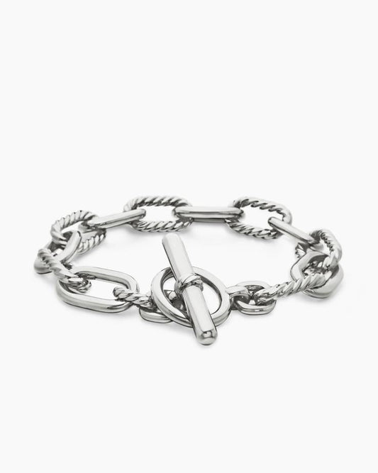 Angled view of the Claspéra Madison rhodium-plated sterling silver bracelet, demonstrating the heavy, substantial feel of the 11mm architectural links.