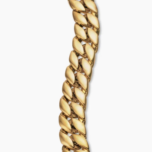 Gold Curb Chain Bracelet on a plain background