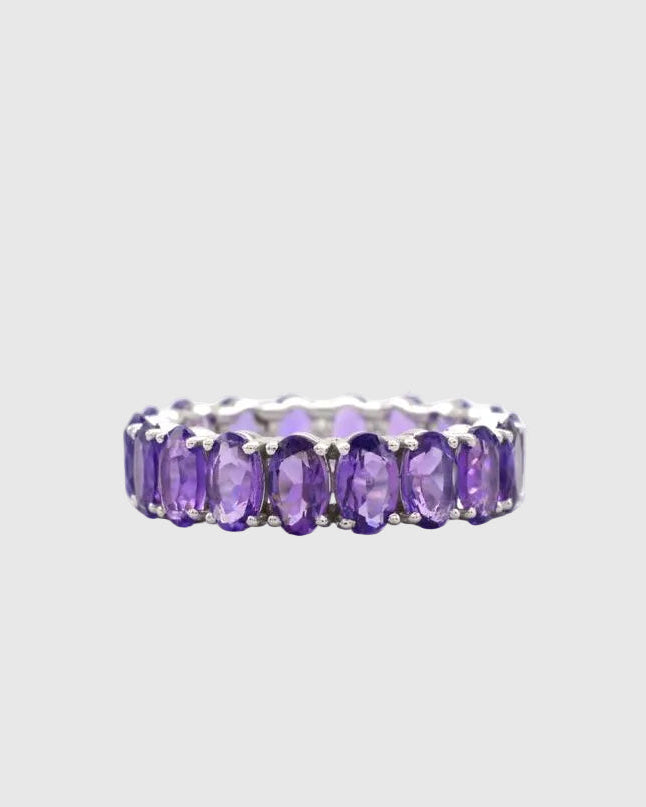 Front profile of the minimalist platinum-polished silver eternity ring featuring a seamless setting of brilliant natural violet amethysts.