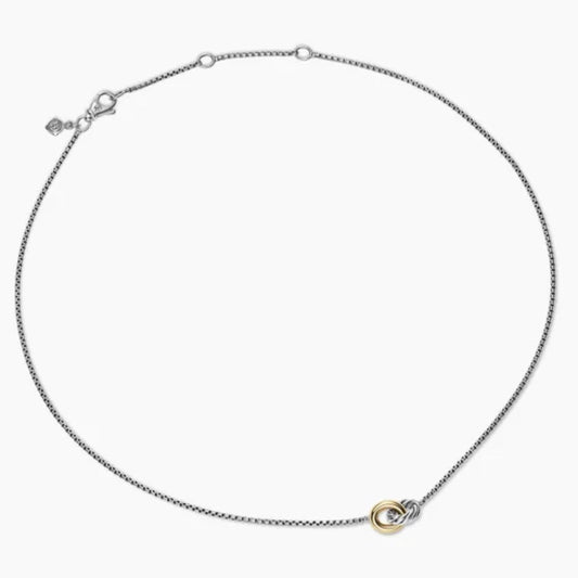 Silver necklace with a small round pendant on a white background