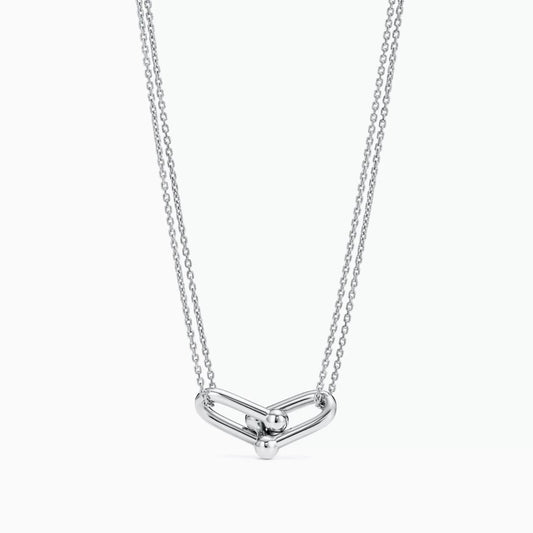 Silver necklace with a unique pendant on a white background