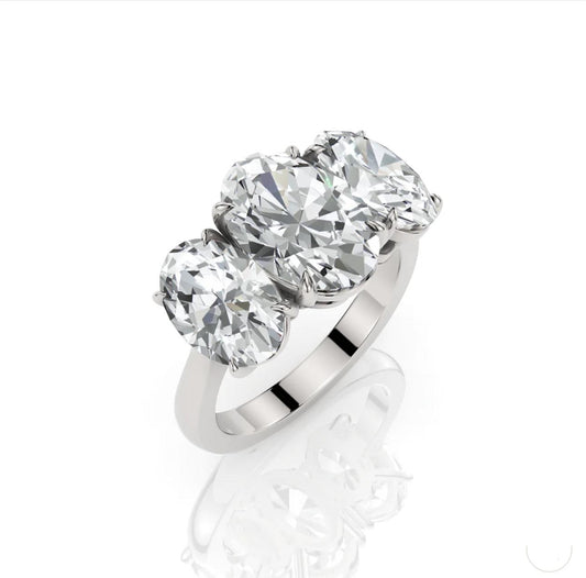 Silver ring with three large diamonds on a white background