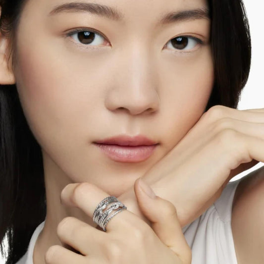 Close-up of a person wearing a ring with a white background