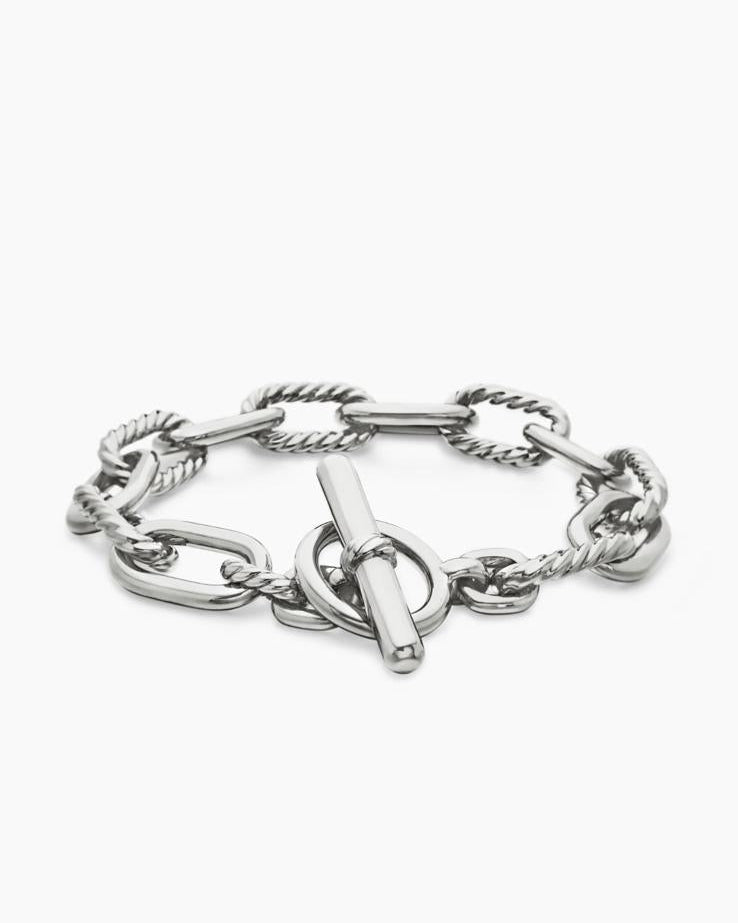 Angled view of the Claspéra Madison rhodium-plated sterling silver bracelet, demonstrating the heavy, substantial feel of the 11mm architectural links.