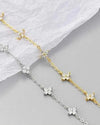 Studio shot showing both the 18K gold-plated and platinum-plated variations of the Fiorella 925 silver bracelet, highlighting the 0.6ct 3EX moissanite floral motifs.