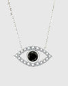 Full studio view of the Auréveil Oculus 925 sterling silver necklace, highlighting the brilliant 1-carat black moissanite center stone framed by a zircon pave halo in an evil eye motif.