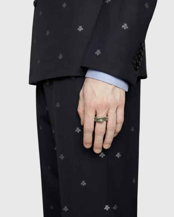 A male model in a tailored dark suit wearing the Aerion Marmont 925 solid silver double-band serpent ring on his hand.