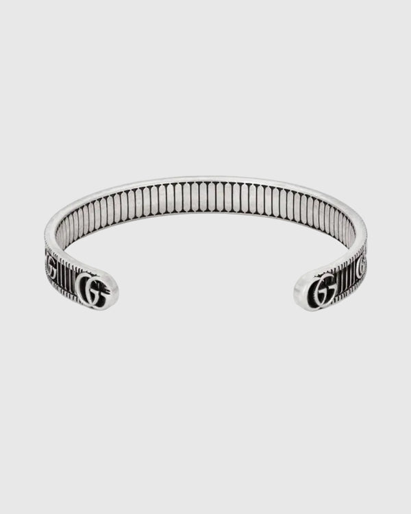 Silver bracelet with Gucci logo on a website page