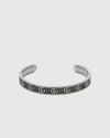 Textured luxury silver bangle cuff with engraved monogram design, minimalist yet bold statement bracelet for women