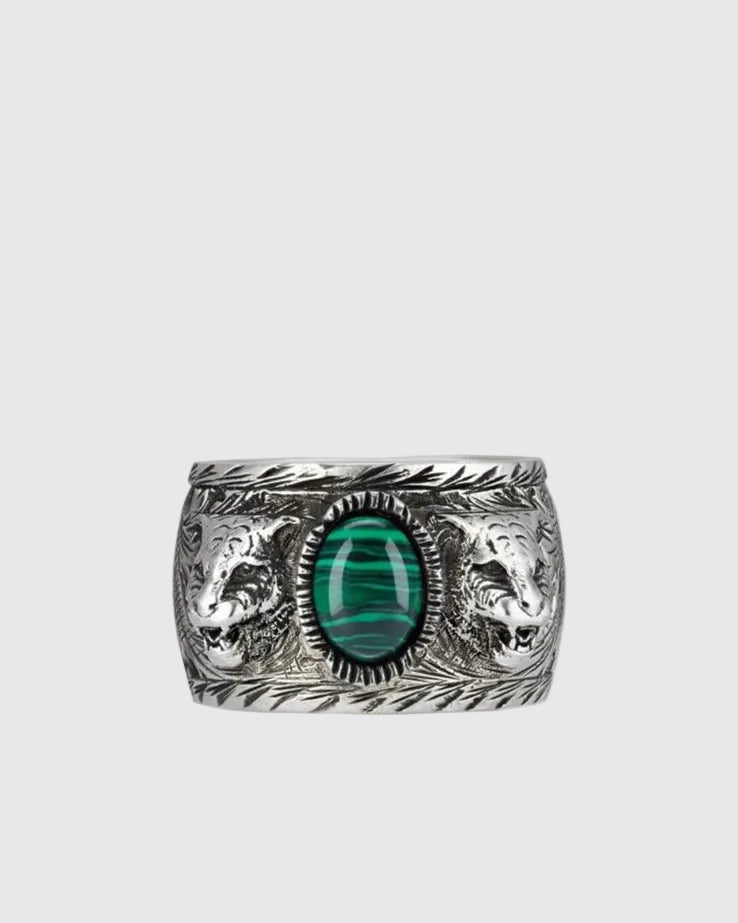 Front view of a vintage 925 silver ring featuring a central green malachite stone guarded by two feline head motifs.