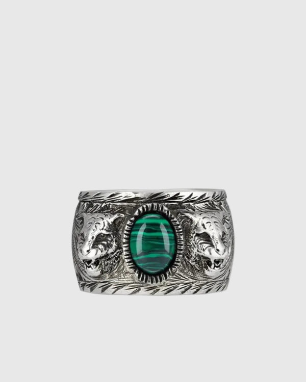 Front view of a vintage 925 silver ring featuring a central green malachite stone guarded by two feline head motifs.