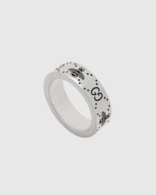 Silver ring with bee design on a white background.