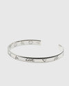 Silver bracelet with engraved text on a white background.