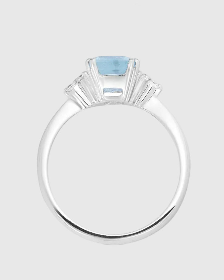  Front face view of the natural blue topaz ring highlighting the flawless aristocratic emerald cut and the sparkling 1.36 carats of side lab-grown diamonds.