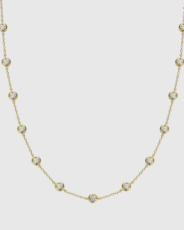 Full studio view of the Auréclaire 2-carat moissanite station necklace in 18K gold PVD plating over solid 925 silver, showcasing perfectly spaced round-cut stones.