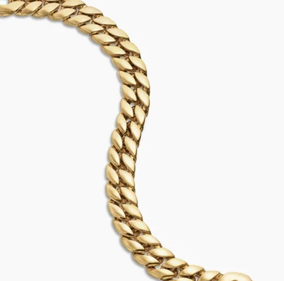 Gold Curb Chain Bracelet on a plain background