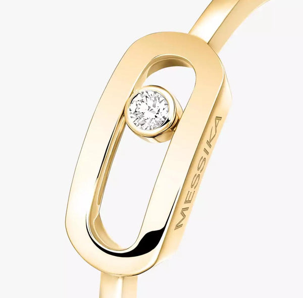 Gold Move Uno ring with a diamond on a white background