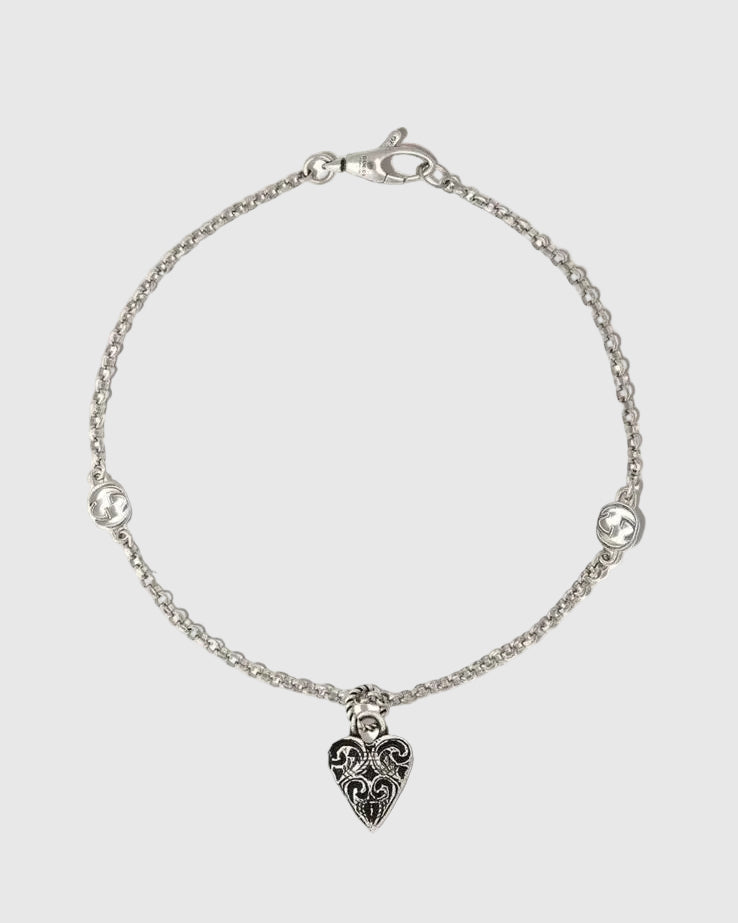 Aerion Cuore 925 sterling silver chain bracelet featuring interlocking monogram charms and an ornately engraved vintage heart pendant.