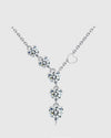 Angled studio view of the 18K white gold rhodium-plated sterling silver lariat necklace, featuring a delicate vertical cascade of AAA+ heart-cut cubic zirconia stones.