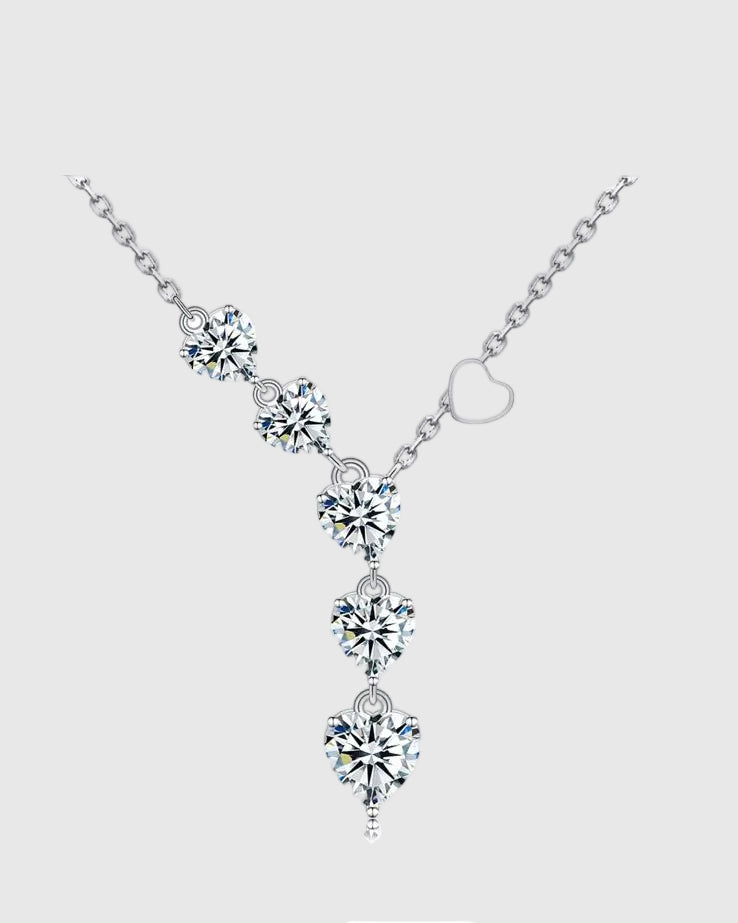 Angled studio view of the 18K white gold rhodium-plated sterling silver lariat necklace, featuring a delicate vertical cascade of AAA+ heart-cut cubic zirconia stones.
