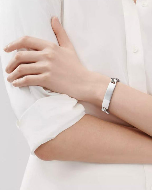 A model wearing the Aerion Signatura massive 60g solid 925 silver Cuban link ID bracelet on the wrist, showcasing its bold 10mm width.