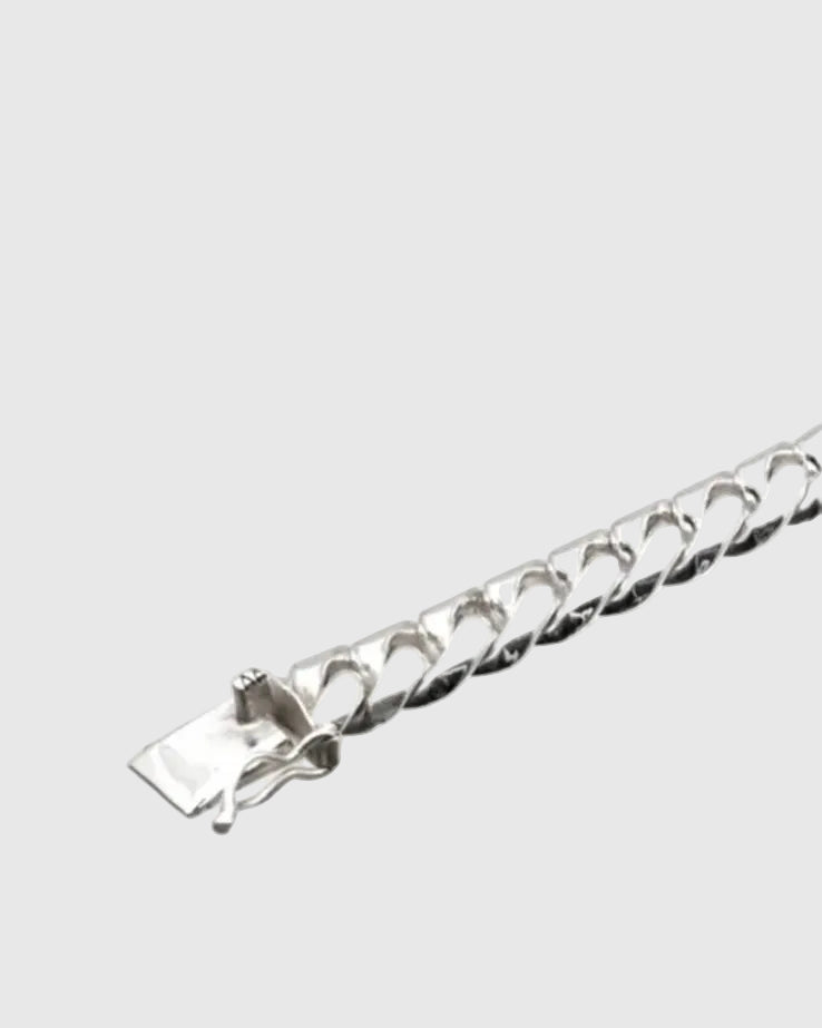Close-up detail of the premium hidden plug-in box clasp with a safety lock mechanism on the solid silver Cuban bracelet.
