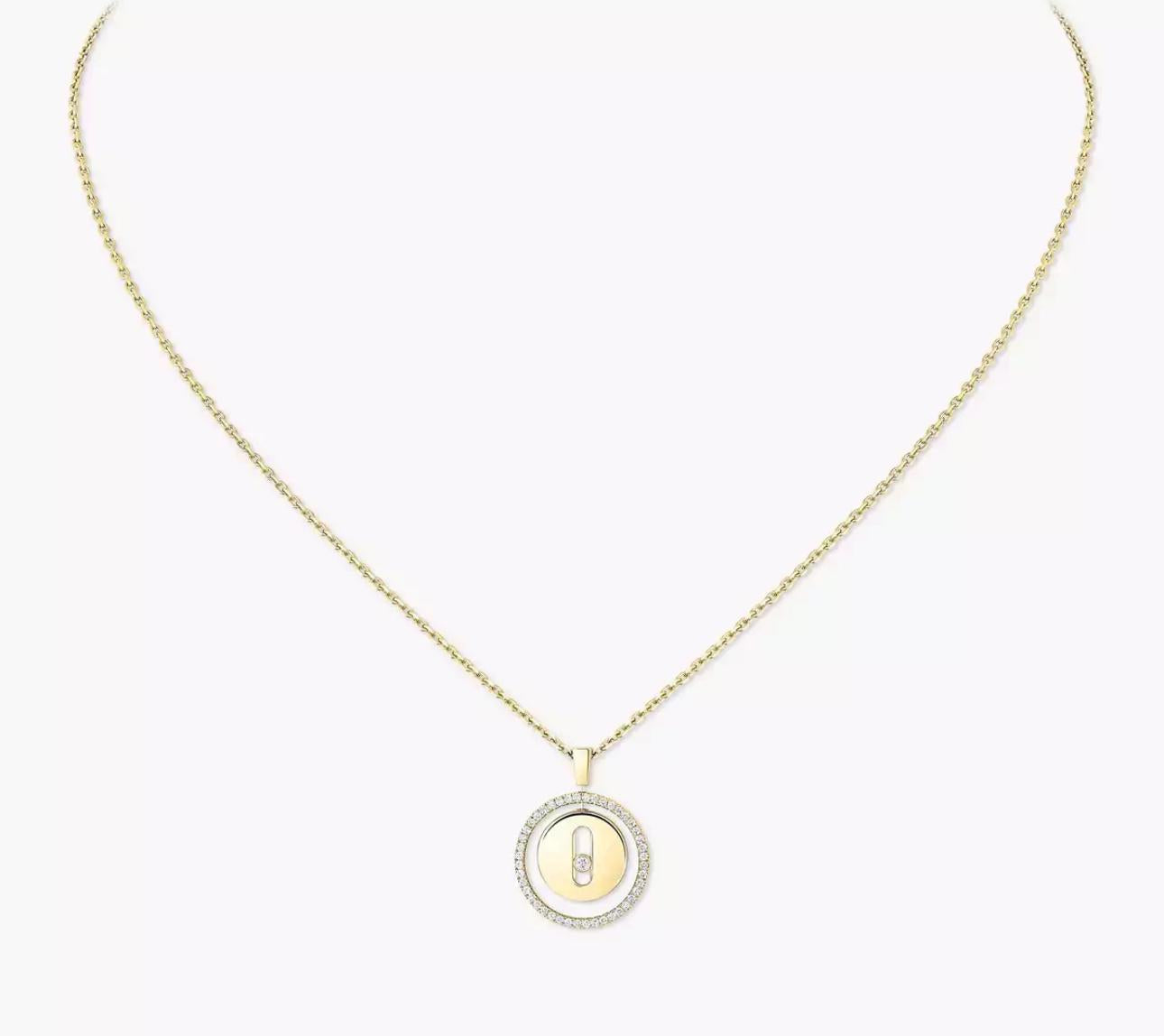 Gold necklace with a round pendant on a white background