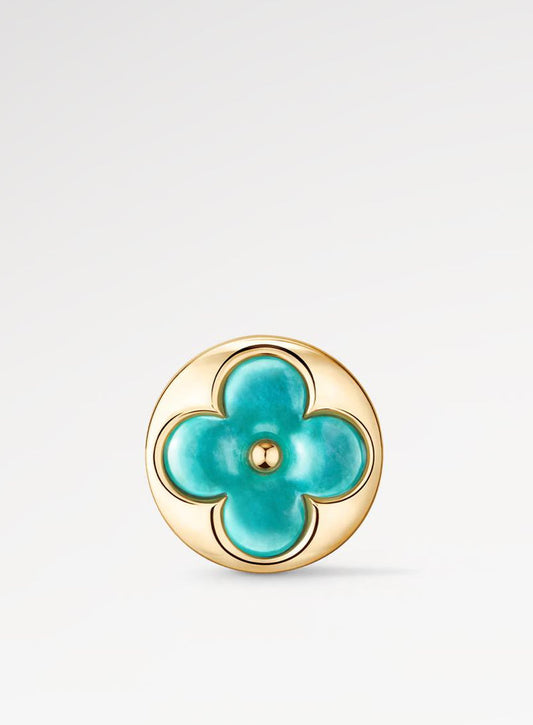 Turquoise flower-shaped earring with gold frame on a light gray background