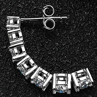 Close-up of Lumora Radiance moissanite earring back showing secure butterfly clasp and prong stone setting, 925 silver with 18K white gold plating