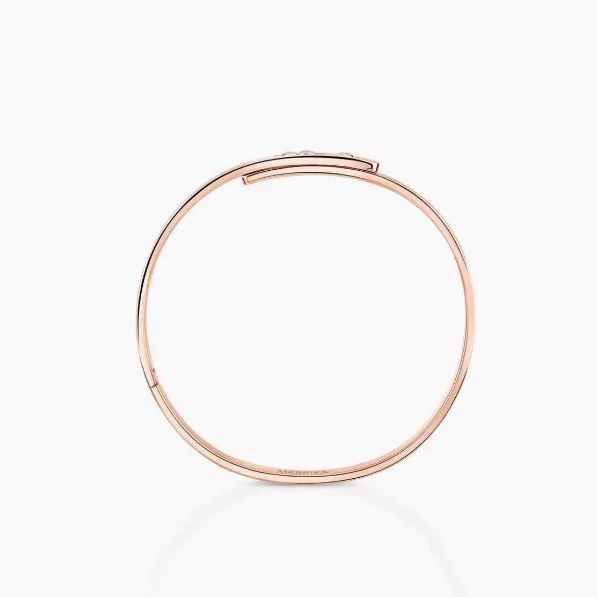 Rose gold diamond bangle bracelet with small diamonds on a white background.
