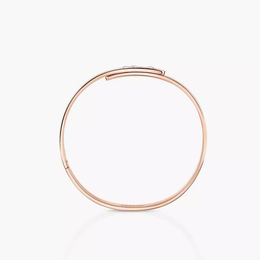Rose gold diamond bangle bracelet with small diamonds on a white background.