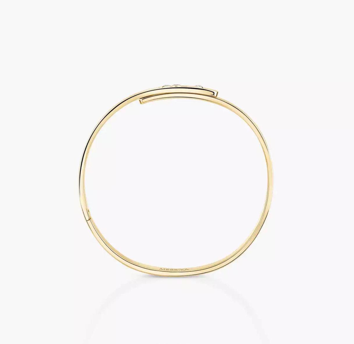 Gold diamond bangle bracelet on a white background