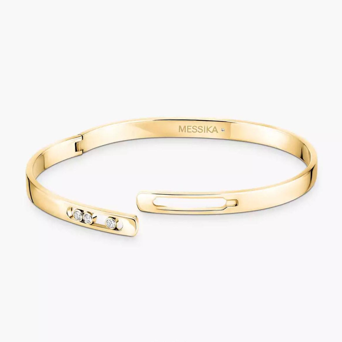 Gold bracelet with diamond accents on a white background, featuring the Messika brand.