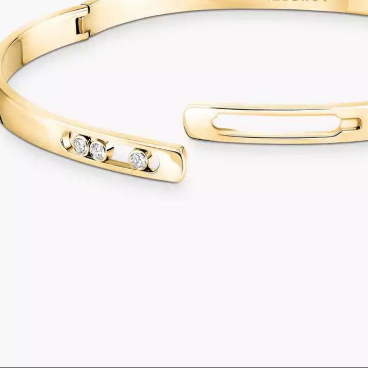 Gold bracelet with diamond accents on a white background, featuring the brand 'MESSIKA'.