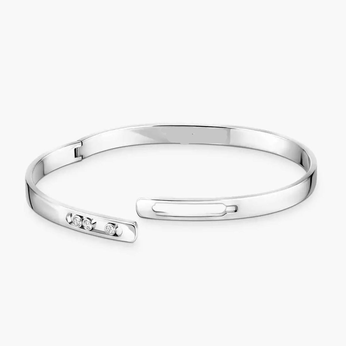 Silver diamond bangle bracelet with small diamonds on a white background.