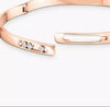 Rose gold bracelet with small diamonds on a white background