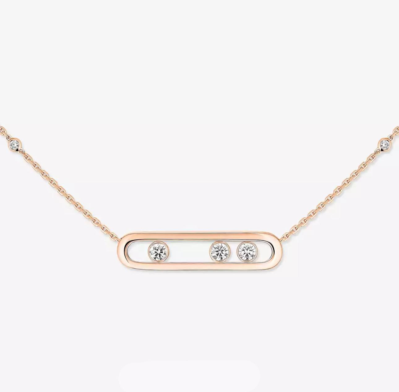 Rose gold necklace with three diamonds on a light gray background