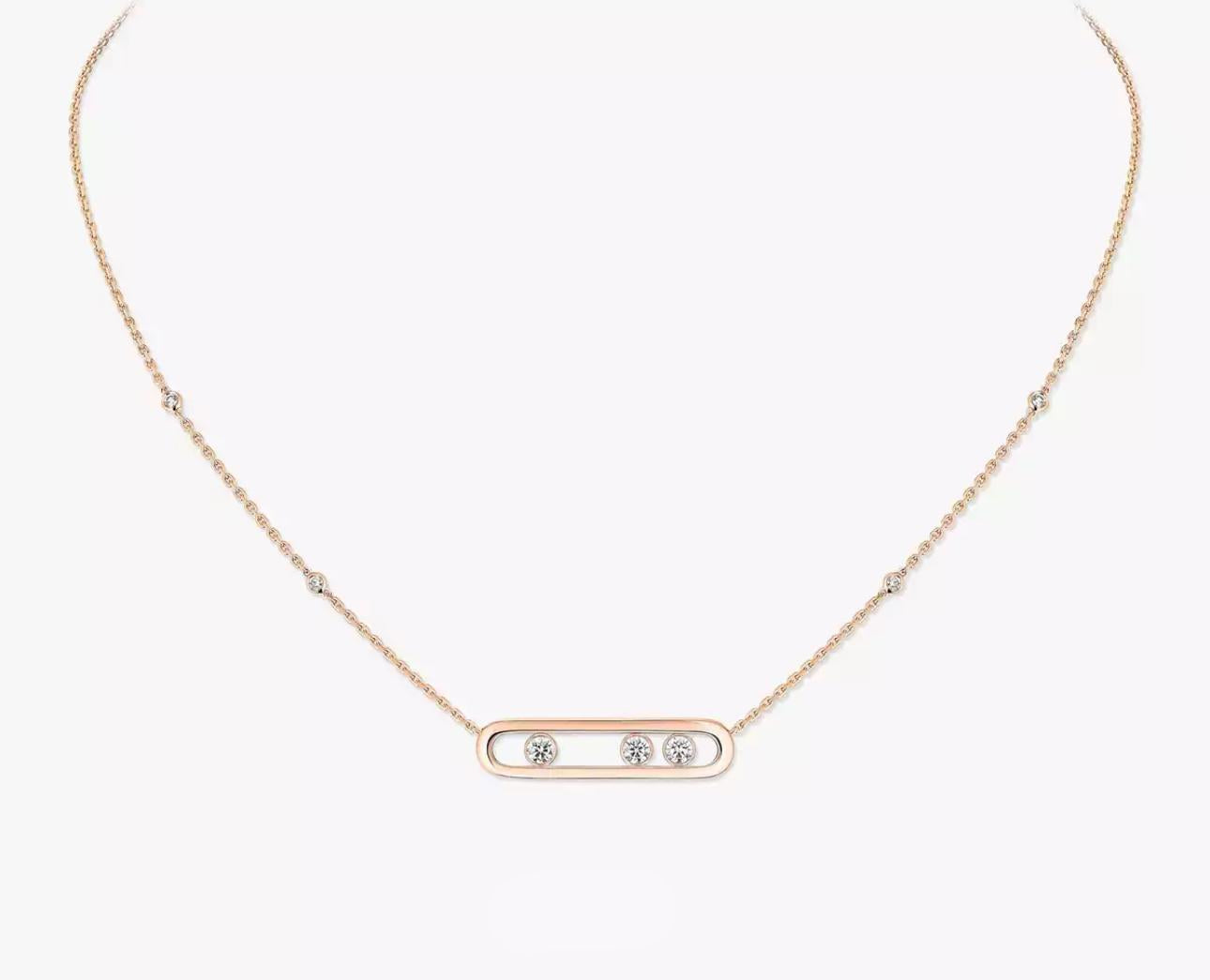 Rose gold necklace with three small diamonds on a white background