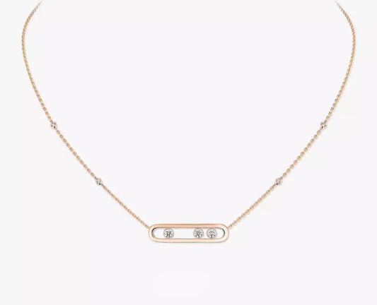 Rose gold necklace with three small diamonds on a white background