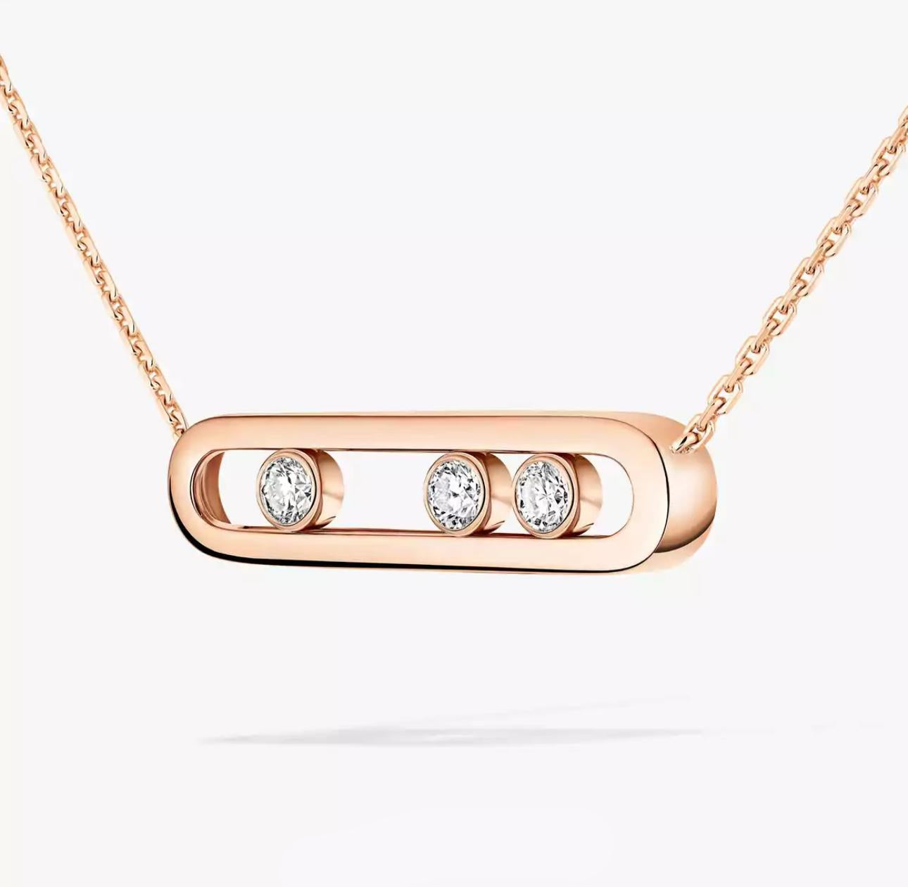 Rose gold necklace with three diamonds on a white background