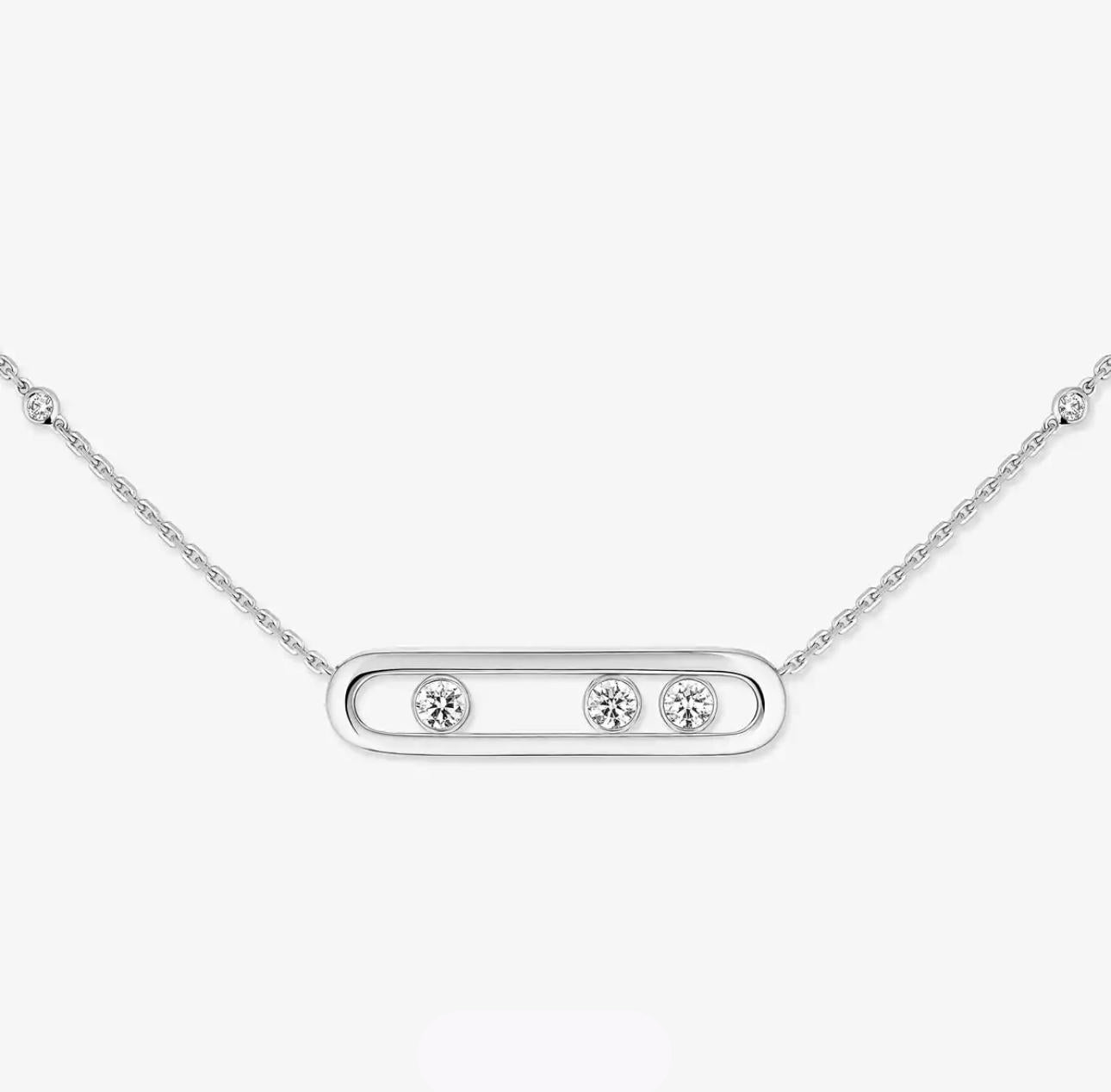 Silver necklace with three round diamonds on a white background