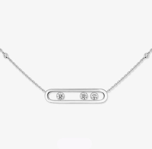 Silver necklace with three round diamonds on a white background