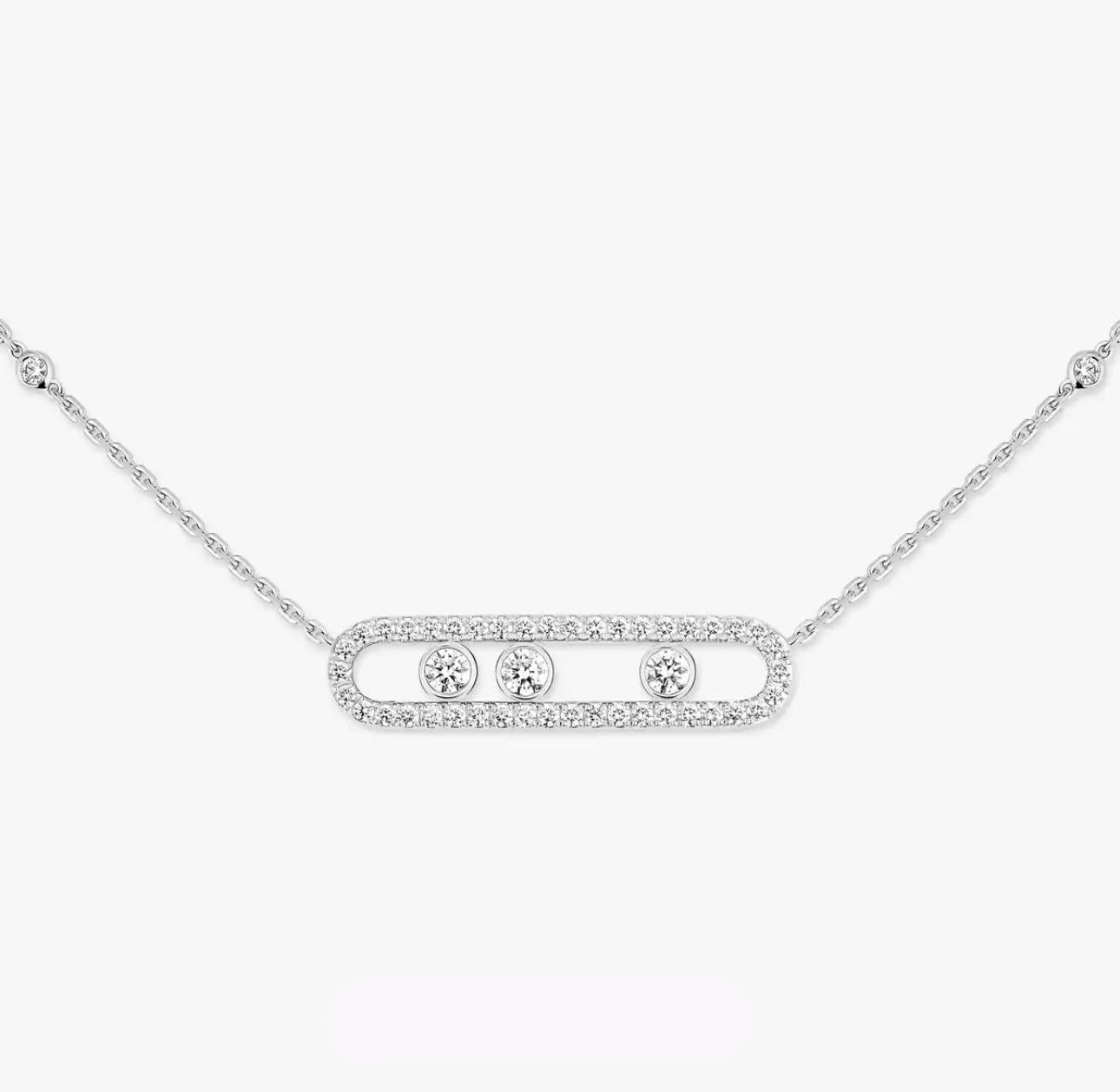 Silver necklace with three round diamonds on a white background