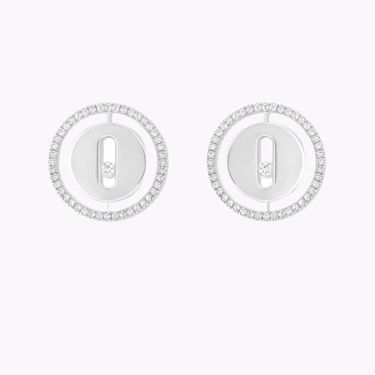Pair of silver earrings with circular designs on a white background