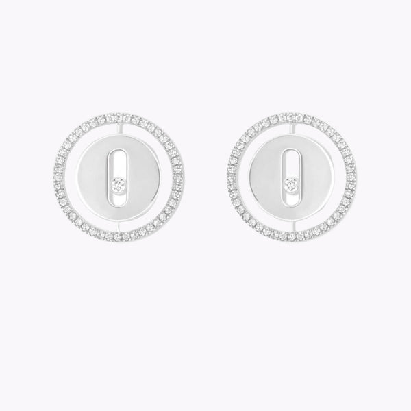 Pair of silver earrings with circular designs on a white background