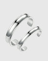 Studio shot of the Argénteo matching twin set of solid Italian 925 silver open cuff bangles, featuring the 8mm and 12mm widths in a smooth, curved silhouette.