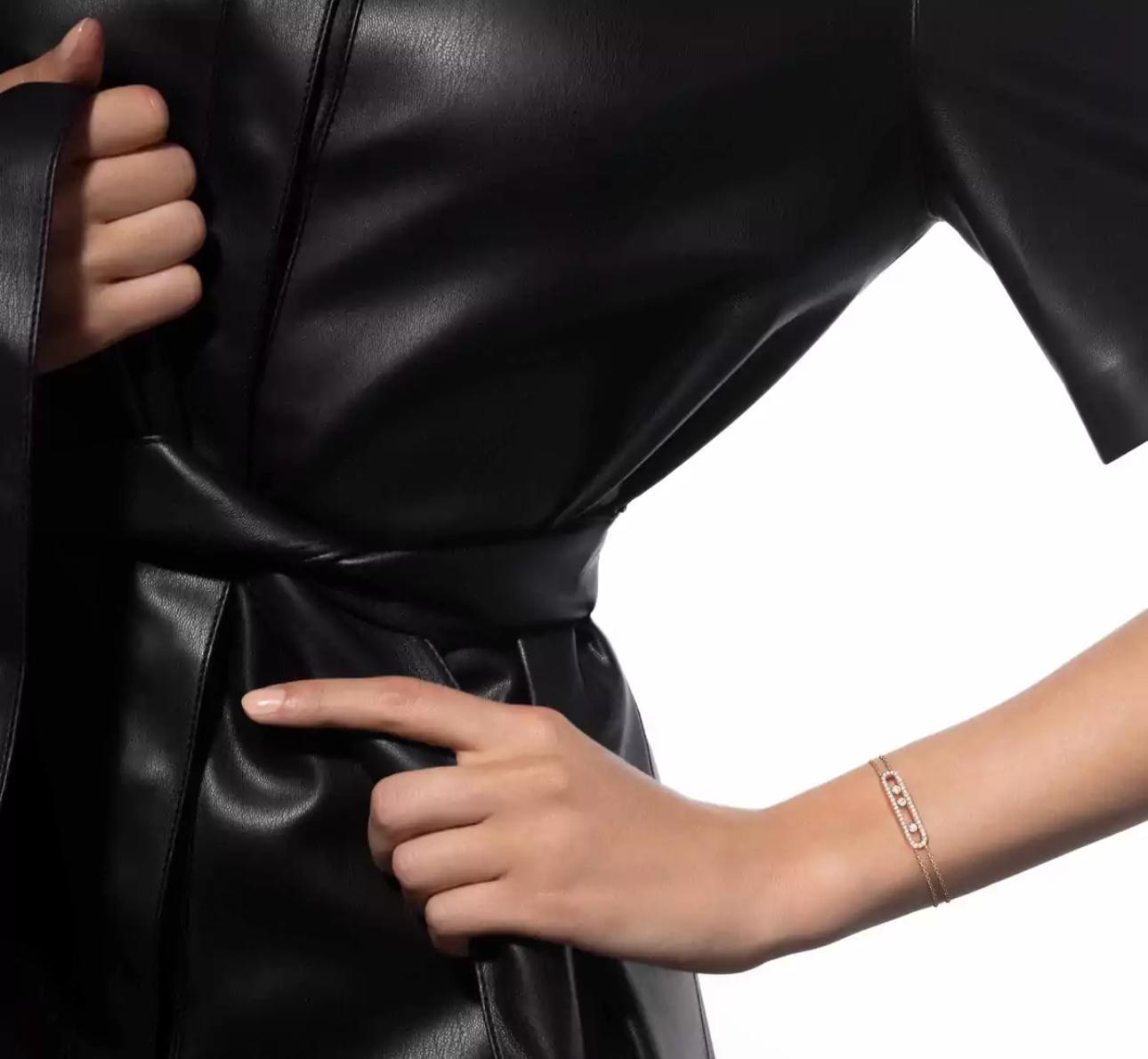 Close-up of Person wearing a A luxury Move Uno bracelet  with a zircon centerpiece on a white background