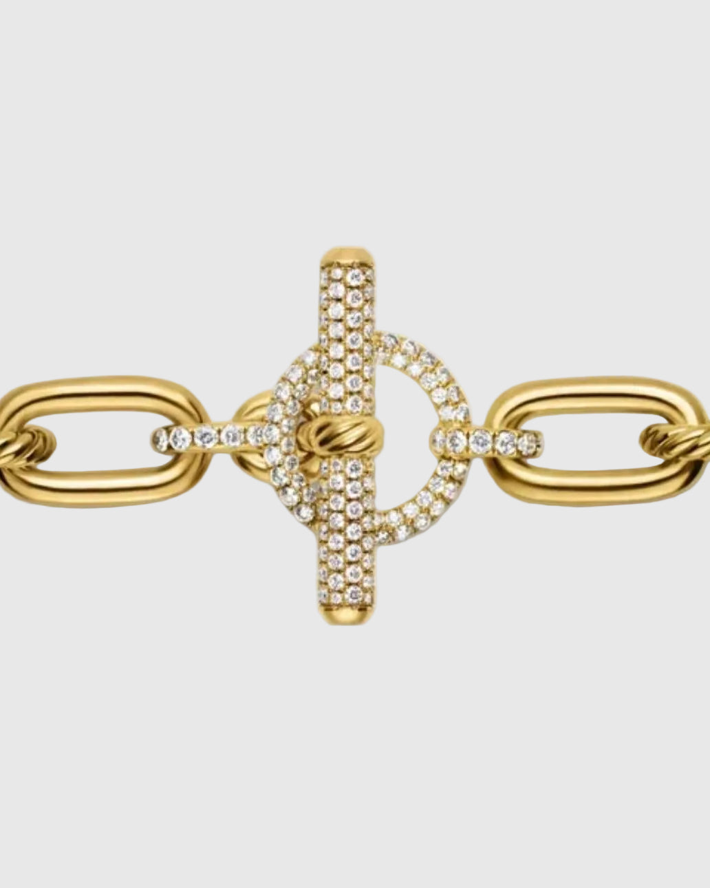 Extreme close-up of the front-facing toggle clasp on the gold chain, showcasing the 2.28 carats of micro-pavé brilliant stones set into the T-bar and circular loop.