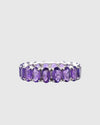 Front profile of the minimalist platinum-polished silver eternity ring featuring a seamless setting of brilliant natural violet amethysts.