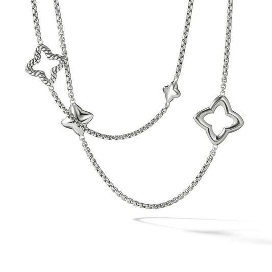 A sterling silver necklace with a four-pointed star pendant and a chain of linked stars.